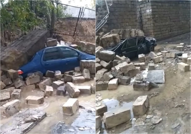 В Баку каменный забор рухнул на автомобили - ВИДЕО