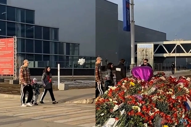 Спустя неделю после теракта люди несут цветы к мемориалу возле «Крокус Сити Холла» - ВИДЕО